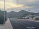 Residential street view with mountain backdrop and palm trees at 4327 E San Gabriel Ave, Phoenix, AZ 85044