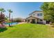 Relaxing backyard oasis with a sparkling pool and grassy area at 3701 E Canyon Way, Chandler, AZ 85249