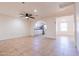 Living room, kitchen view, tile floors, ceiling fan at 7322 N 61St Ave, Glendale, AZ 85301