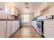 White kitchen cabinets, tile floors, and a double sink at 7322 N 61St Ave, Glendale, AZ 85301