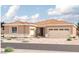 Tan two-story house with a three-car garage at 10512 S 48Th Gln, Laveen, AZ 85339