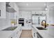 Modern kitchen with white cabinets, quartz countertops, and stainless steel appliances at 2761 W Sunbeam Ln, Queen Creek, AZ 85142