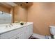 Double sink bathroom with beige walls and white cabinets at 6545 N 29Th St, Phoenix, AZ 85016