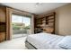 Secondary bedroom with built-in shelving and private balcony access at 6545 N 29Th St, Phoenix, AZ 85016