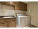 Laundry room with washer, dryer, and ample cabinet space at 6545 N 29Th St, Phoenix, AZ 85016