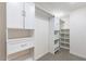 Spacious walk-in closet with built-in shelving and hanging rods at 7344 E Keim Dr, Scottsdale, AZ 85250