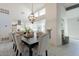 Elegant dining area with a large chandelier and modern decor at 7344 E Keim Dr, Scottsdale, AZ 85250