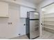 Walk-in pantry and laundry area with stainless steel refrigerator at 7344 E Keim Dr, Scottsdale, AZ 85250