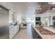 Updated kitchen featuring granite counters, island, and breakfast bar at 7344 E Keim Dr, Scottsdale, AZ 85250