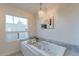 Relaxing bathroom with soaking tub and marble tile surround at 7344 E Keim Dr, Scottsdale, AZ 85250