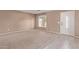 Living room with carpeted floor, neutral walls, and front door at 11116 W Campbell Ave, Phoenix, AZ 85037