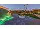 Serene water feature with a green tile wall and fire pit at 4723 E Desert Park Pl, Paradise Valley, AZ 85253