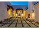 Elegant courtyard entry with tile flooring, fireplace, and arched entryway at 4723 E Desert Park Pl, Paradise Valley, AZ 85253