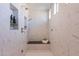 Large walk-in shower with marble tile and built-in shelving at 4723 E Desert Park Pl, Paradise Valley, AZ 85253