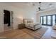 Bright bedroom with hardwood floors and access to a private patio at 4723 E Desert Park Pl, Paradise Valley, AZ 85253