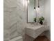 Spa-like bathroom with marble chevron tile and floating vanity at 4723 E Desert Park Pl, Paradise Valley, AZ 85253