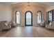 Bright entryway with stone wall, arched doorway and hardwood floors at 4723 E Desert Park Pl, Paradise Valley, AZ 85253