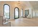Bright entryway with stone wall, arched doorway and hardwood floors at 4723 E Desert Park Pl, Paradise Valley, AZ 85253
