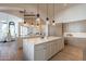 Gourmet kitchen with large island, stainless steel appliances, and light wood flooring at 4723 E Desert Park Pl, Paradise Valley, AZ 85253