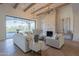 Open concept living room with stone fireplace and access to backyard at 4723 E Desert Park Pl, Paradise Valley, AZ 85253