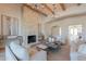 Spacious living room with stone fireplace and exposed wood beams at 4723 E Desert Park Pl, Paradise Valley, AZ 85253