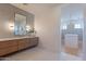 Elegant bathroom features a floating vanity, marble flooring, and a large mirror at 4723 E Desert Park Pl, Paradise Valley, AZ 85253