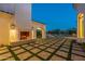 Outdoor fireplace and patio with mountain views at night at 4723 E Desert Park Pl, Paradise Valley, AZ 85253