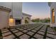 Outdoor fireplace and patio with mountain views at dusk at 4723 E Desert Park Pl, Paradise Valley, AZ 85253