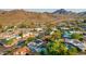 Aerial view of a residential neighborhood with mountain views and numerous homes with pools at 9020 N 33Rd Way, Phoenix, AZ 85028