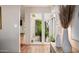 View of a charming courtyard with plants, visible through glass doors from inside the home at 9020 N 33Rd Way, Phoenix, AZ 85028