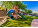 Playset in grassy backyard with pool in background at 9020 N 33Rd Way, Phoenix, AZ 85028