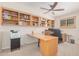 Bright home office features built-in shelving and a large desk at 9020 N 33Rd Way, Phoenix, AZ 85028
