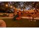 Landscaped backyard with playset and string lights at 9020 N 33Rd Way, Phoenix, AZ 85028