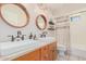 Bathroom with a double vanity, neutral color scheme, and updated fixtures at 9020 N 33Rd Way, Phoenix, AZ 85028