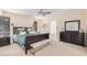 Main bedroom with a king-size bed, large mirror, and plenty of natural light at 9020 N 33Rd Way, Phoenix, AZ 85028
