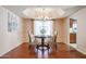 Bright dining room featuring hardwood floors and a charming chandelier at 9118 W Topeka Dr, Peoria, AZ 85382