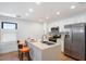 Modern kitchen with white cabinets, stainless steel appliances, and an island at 16844 E Ave Of The Fountains -- # 102, Fountain Hills, AZ 85268