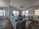 Spacious living room with gray sofas and ceiling fan at 650 N Hawes Rd # 3809, Mesa, AZ 85207