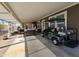 Spacious covered patio, wicker furniture and golf cart at 650 N Hawes Rd # 3809, Mesa, AZ 85207