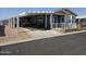 Mobile home with covered carport and landscaped yard at 650 N Hawes Rd # 3809, Mesa, AZ 85207