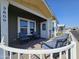 Inviting front porch with patio furniture and white railing at 650 N Hawes Rd # 3809, Mesa, AZ 85207
