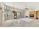 Spacious living room with a fireplace, tiled floors, and large windows at 8874 E Flathorn Dr, Scottsdale, AZ 85255