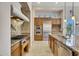 Gourmet kitchen featuring double ovens, gas cooktop, and custom cabinetry at 8874 E Flathorn Dr, Scottsdale, AZ 85255