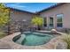 Relaxing hot tub with a stone waterfall feature at 8874 E Flathorn Dr, Scottsdale, AZ 85255
