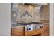 Gas cooktop with custom tile backsplash and granite countertop at 8874 E Flathorn Dr, Scottsdale, AZ 85255