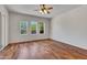 Bedroom with hardwood floors, multiple windows, and ceiling fan at 8874 E Flathorn Dr, Scottsdale, AZ 85255