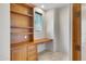 Home office with built-in wooden desk and shelving at 8874 E Flathorn Dr, Scottsdale, AZ 85255