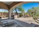 Covered patio overlooks a firepit and outdoor kitchen at 8874 E Flathorn Dr, Scottsdale, AZ 85255