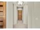 Hallway with tiled floors and a wooden door leading to another room at 8874 E Flathorn Dr, Scottsdale, AZ 85255