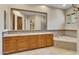 Bathroom with double vanity, large mirror, and soaking tub at 8874 E Flathorn Dr, Scottsdale, AZ 85255